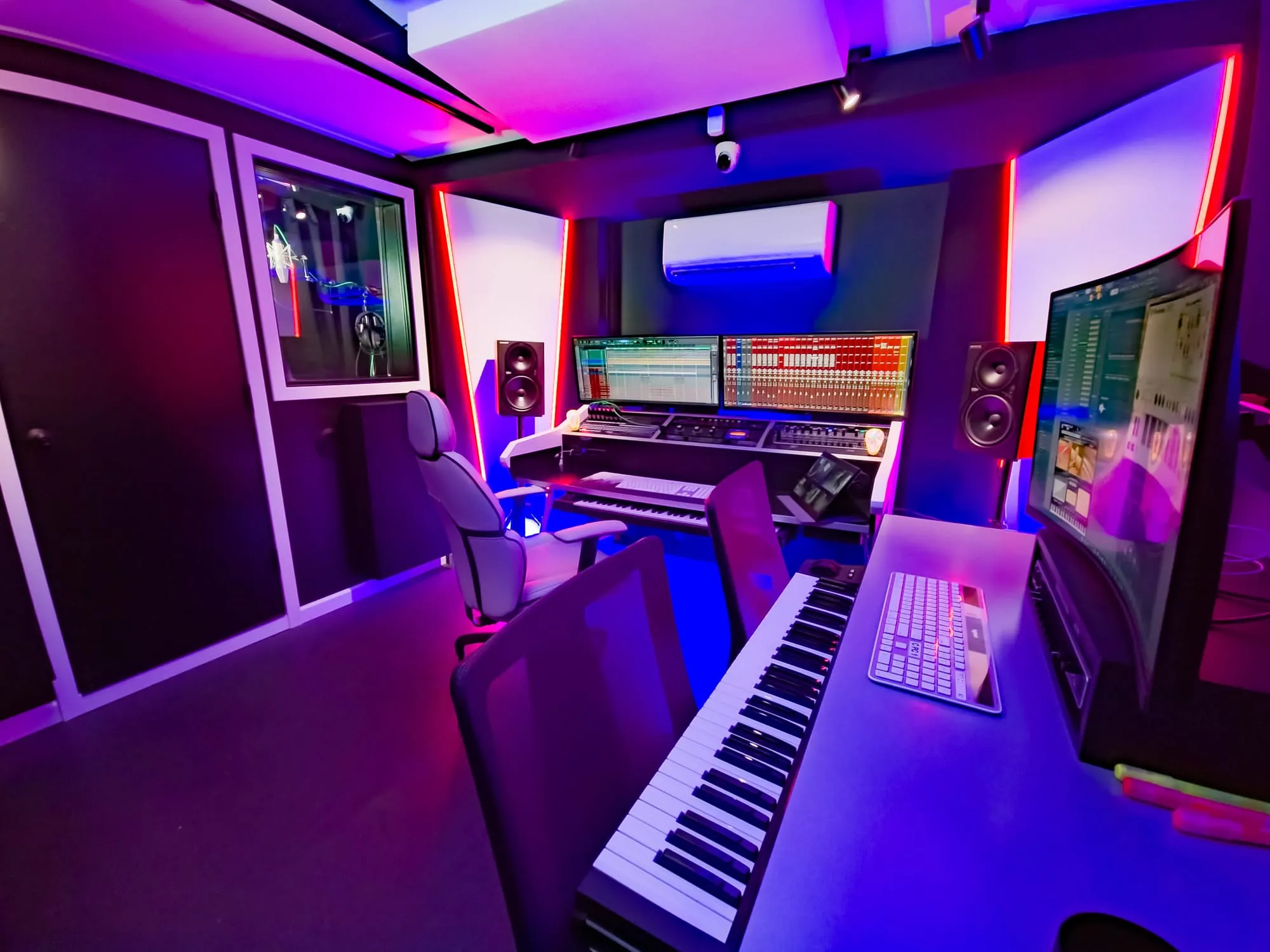 Studio C in purple light: keys, monitors, and a session ready to go.